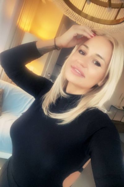Blonde London escort Mona is wearing a black jumper in this selfie 