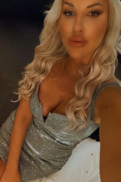 Busty blonde London escort Ana looks very sexy in a silver dress 
