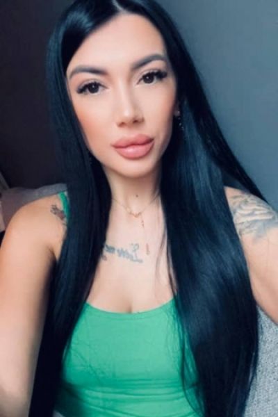 Brunette escort lady Trixie is wearing a green top in this selfie 