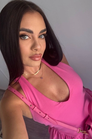 Blossom is wearing a pink dress in this selfie picture