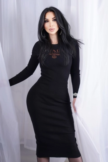 Rosaline, elegant Russian escort in black bodycon dress with flowing dark hair