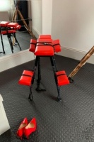 Red and blac bench that you could be tired to