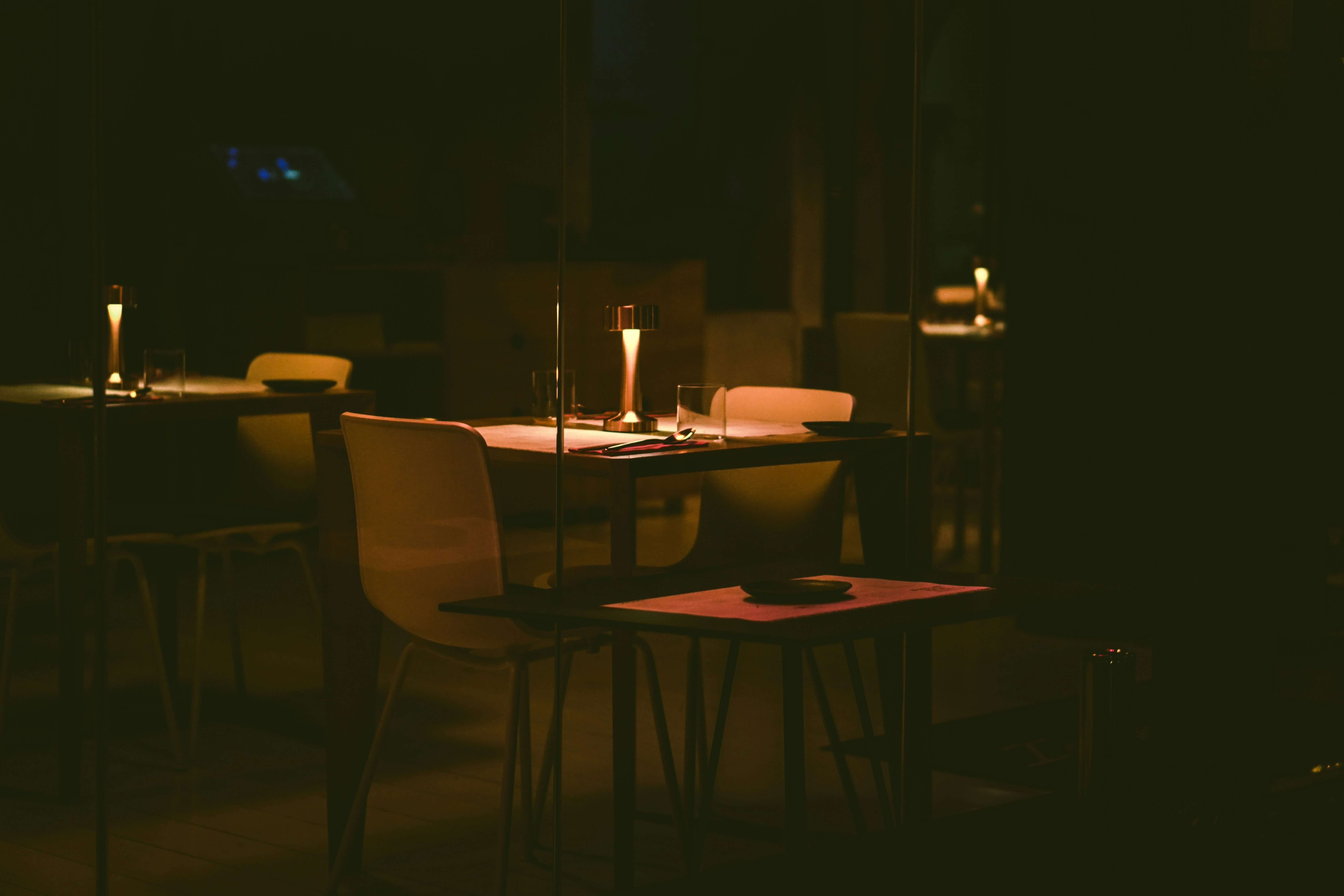 a candlelit table in a dimly lit London restaurant