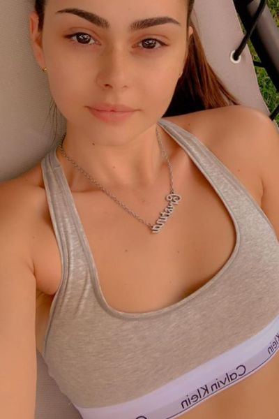Selfie of Sally wearing a grey Calvin Klein sports bra