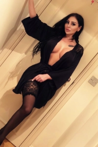 Aly wearing an open black dressing gown looking busty