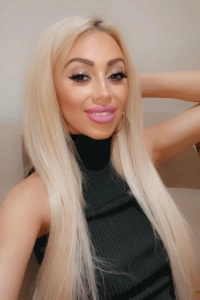 Bonnie has pink lips and a lovely smile in this photo 