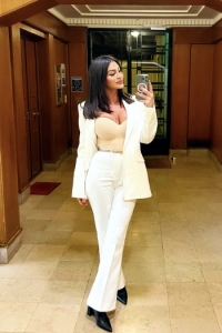 Selfie of Nour in a white trouser suit 