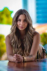 Close up picture of a sexy Brazilian lady at a pool bar
