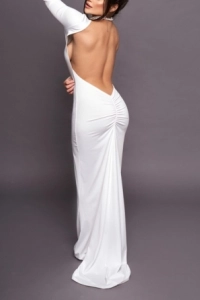 High class brunette London escort Heidy is wearing a long white dress 