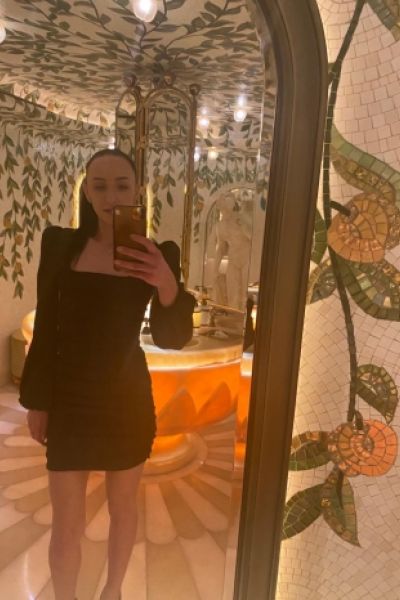 Nicole has taken a mirror selfie of her in a black dress 