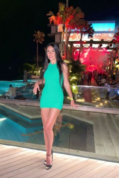 A very sexy Russian lady is pictured wearing a green dress 