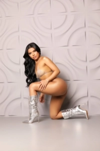 A very sexy Brazilian escort is wearing cowboy boots 