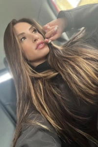 A sexy elite London escort in the back of a black taxi 