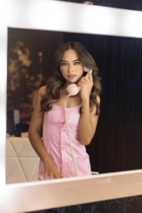 Female Brazilian escort wearing a pink dress 