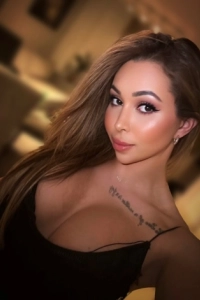 Sexy European ts escort wearing a low cut top 