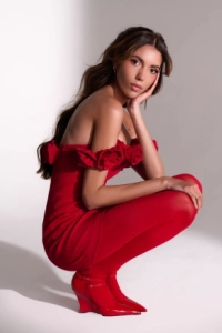 Lola is sitting down wearing red underwear 