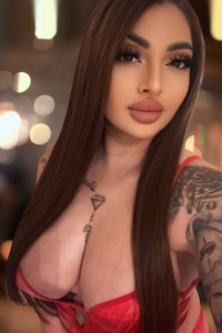A selfie of an escort with large boobs and big blowjob lips 