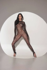 Bernadette is dressed in a body stocking and high heels 