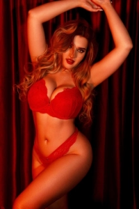 Busty blonde London escort pictured wearing red lace lingerie 