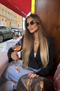 Sexy lady enjoying a drink outside in the fresh air 