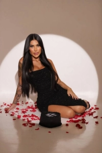 A sexy brunette Brazilian lady sitting on the floor 