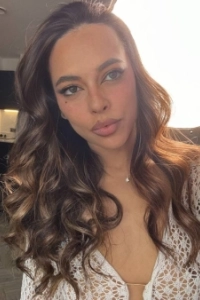 Young sexy Brazilian lady Auri took this selfie of her wearing a white top 