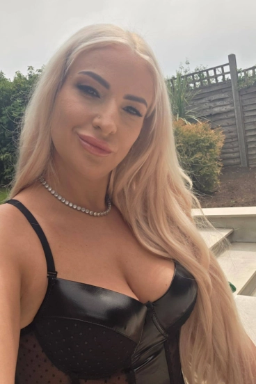 A selfie of a blonde escort named Ruby showing off her boobs 