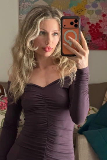 High class London escort Zendaia wearing a purple dress 