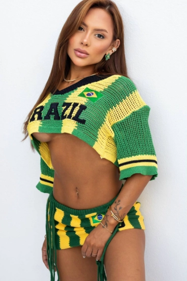 Adina in a Brazil knit co-ord against a white wall