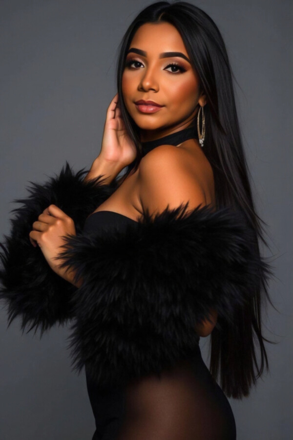 Jessamine Brazilian escort in a fitted black bodysuit with dramatic fur cuffs