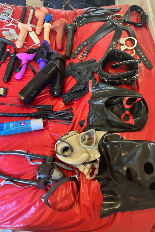 A red sheet with a lot of sex games masks on it