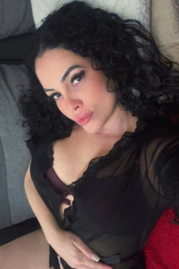 Mella taking a selfie in a black lace camisole
