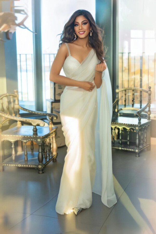 A beautiful Indian escorts wearing a long white dress