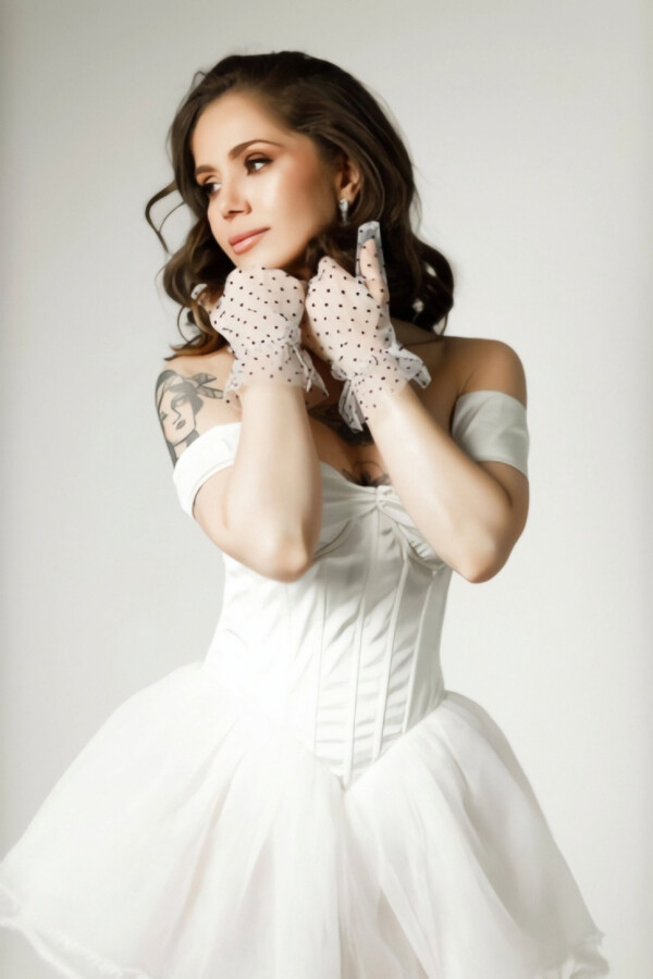 London escort from brazil Millena wearing a white dress