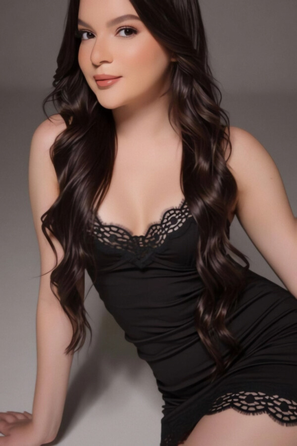 Brazilian beauty Mila is pictured dressed in black lingerie