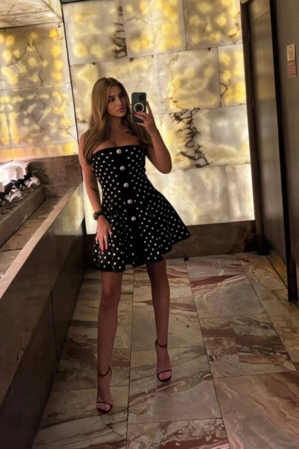 Selfie of high class escort Chardonnay wearing a dress and sexy high heels