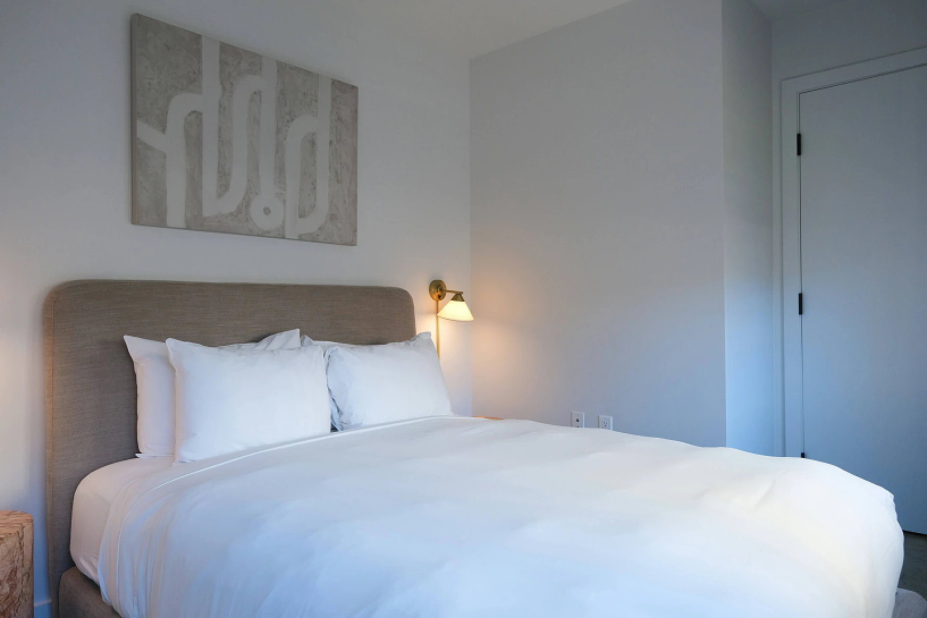 a clean white bed with fresh sheets